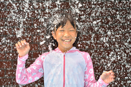 Girl playing in the poolの写真素材