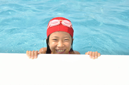 Girl playing in the poolの写真素材