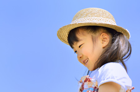 Girl smile in the blue sky (straw hat)