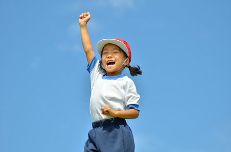 Girl cheering in the blue sky (Sports day)