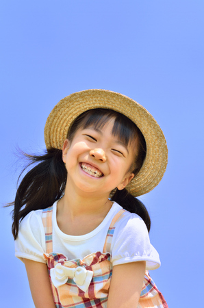 Girls smiling in the blue skyの写真素材