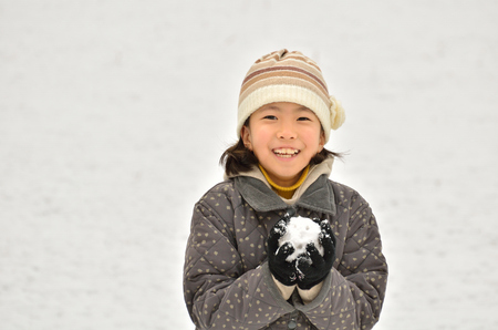 Girls play with snowの写真素材