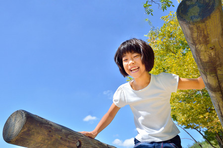 School girl enjoying herself at the playgroundの写真素材