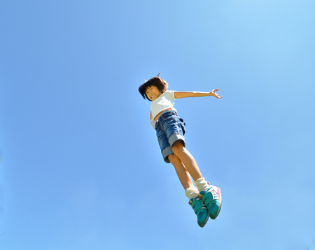 Girls jumping in the blue skyの写真素材