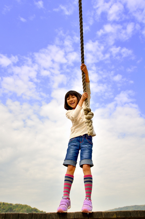 Girls playing in the blue skyの写真素材