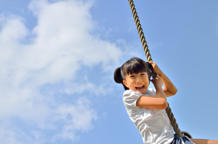 Girls playing in the blue skyの写真素材