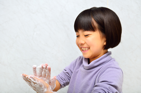 Girls washing her handsの写真素材