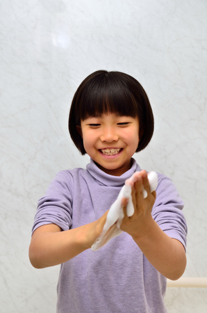 Girls washing her handsの写真素材