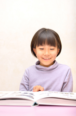 Girls reading bookの写真素材