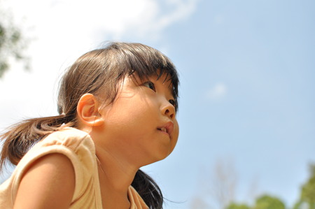 Girl's smiling in the blue skyの写真素材