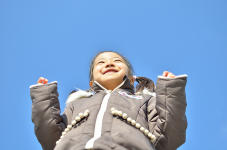Girl's smiling in the blue skyの写真素材