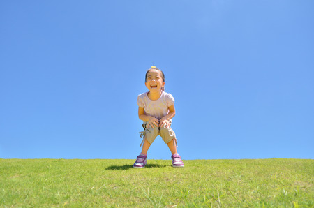 Girl's smiling in the blue skyの写真素材