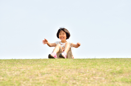 Girl's smiling in the blue skyの写真素材