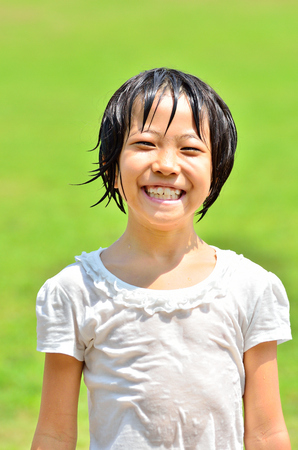 Girl's smiling in the grasslandの写真素材
