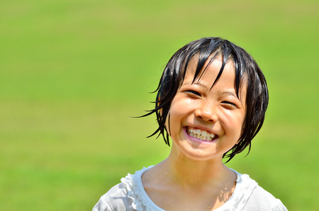 Girl's smiling in the grasslandの写真素材