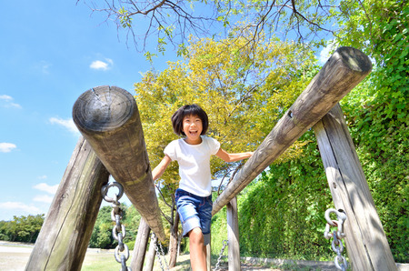 Elementary school girl is enjoying herself at the playground