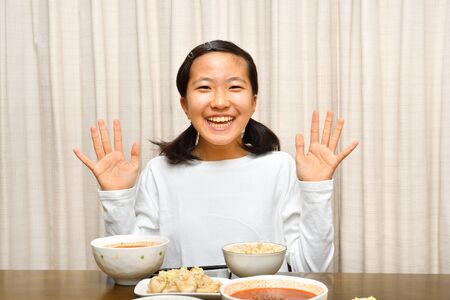 Japanese girl enjoys having dinnerの写真素材