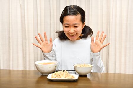 Japanese girl enjoys having dinnerの写真素材