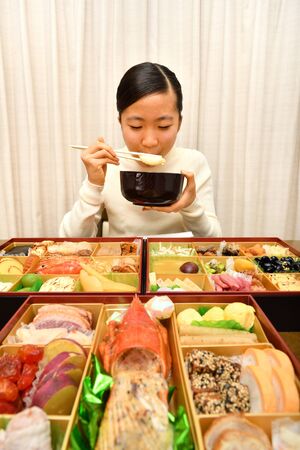 Japanese Girl Enjoys New Year's Party at Homeの写真素材