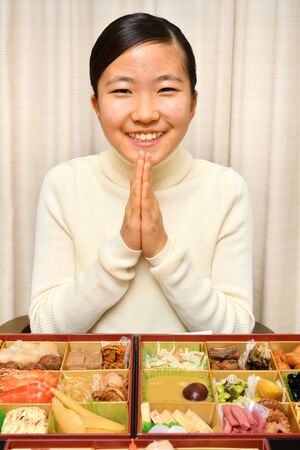 Japanese Girl Enjoys New Year's Party at Homeの写真素材