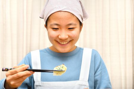 Japanese girl enjoys having Chinese dumplingsの写真素材