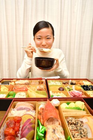 Japanese Girl Enjoys New Year's Party at Homeの写真素材