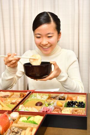 Japanese Girl Enjoys New Year's Party at Homeの写真素材