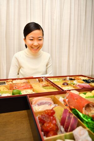 Japanese Girl Enjoys New Year's Party at Homeの写真素材