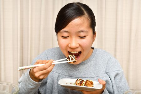 Japanese girl enjoys Octopus fritters partyの写真素材