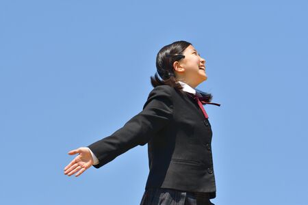 Japanese girl looking up in the blue skyの写真素材