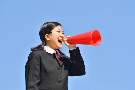 Japanese girl cheering in the blue skyの写真素材