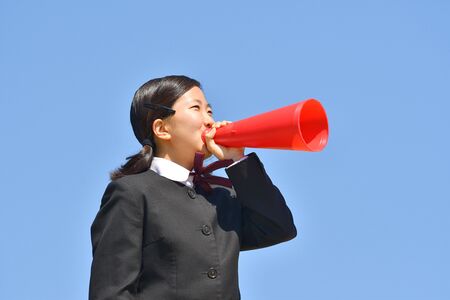 Japanese girl cheering in the blue skyの写真素材