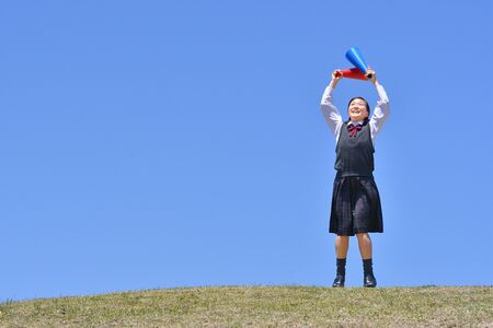 Japanese girl cheering in the blue sky