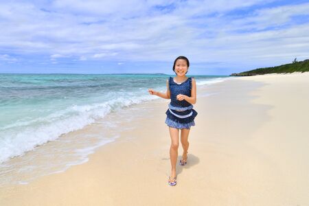 Japanese girl running in the beach - Okinawa Miyakojimaの写真素材