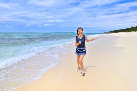 Japanese girl running in the beach - Okinawa Miyakojimaの写真素材