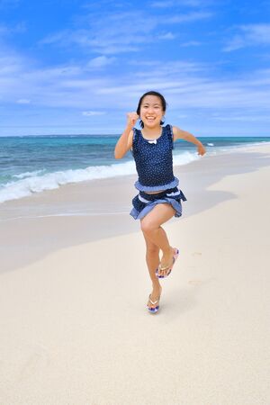 Japanese girl running in the beach - Okinawa Miyakojimaの写真素材