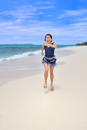 Japanese girl running in the beach - Okinawa Miyakojimaの写真素材