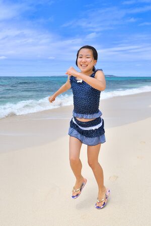 Japanese girl running in the beach - Okinawa Miyakojimaの写真素材