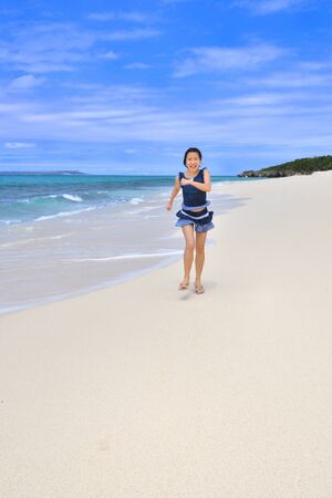 Japanese girl running in the beach - Okinawa Miyakojimaの写真素材