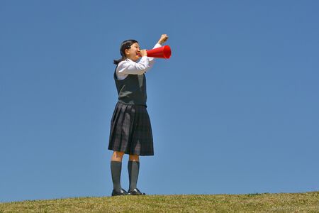 Japanese girl cheering in the blue skyの写真素材