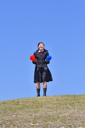 Japanese girl cheering in the blue skyの写真素材