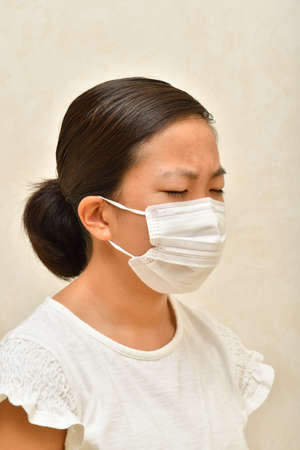 Japanese girl wearing mask not to suffer illnessesの写真素材