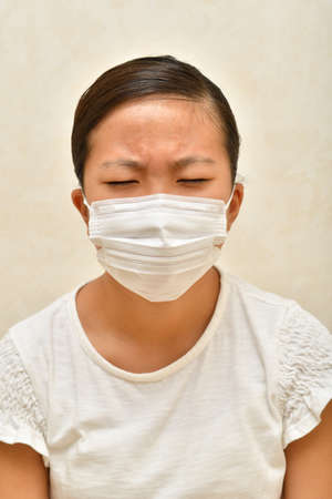 Japanese girl wearing mask not to suffer illnessesの写真素材