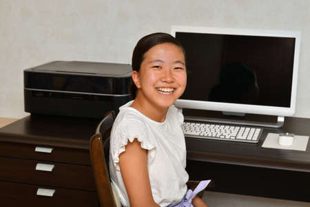 Japanese girl operating personal computerの写真素材