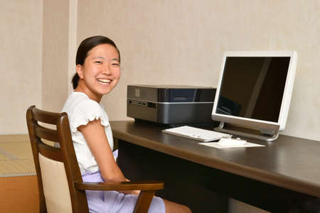 Japanese girl operating personal computerの写真素材