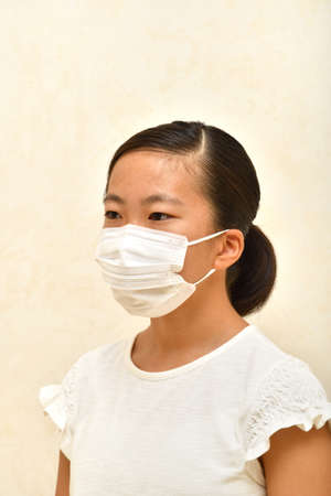 Japanese girl wearing mask not to suffer illnessesの写真素材