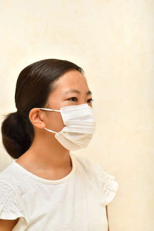 Japanese girl wearing mask not to suffer illnessesの写真素材