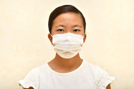 Japanese girl wearing mask not to suffer illnessesの写真素材