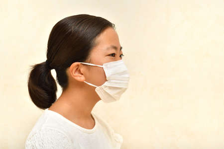 Japanese girl wearing mask not to suffer illnessesの写真素材