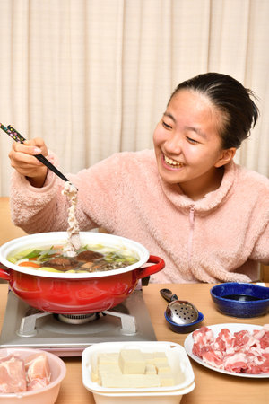 Japanese girl enjoying Japanese Nabe partyの写真素材